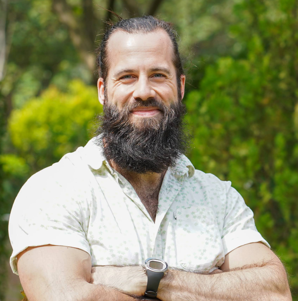 Photo of Dr. Jonathan Cybulski with arms crossed, smiling, outdoors